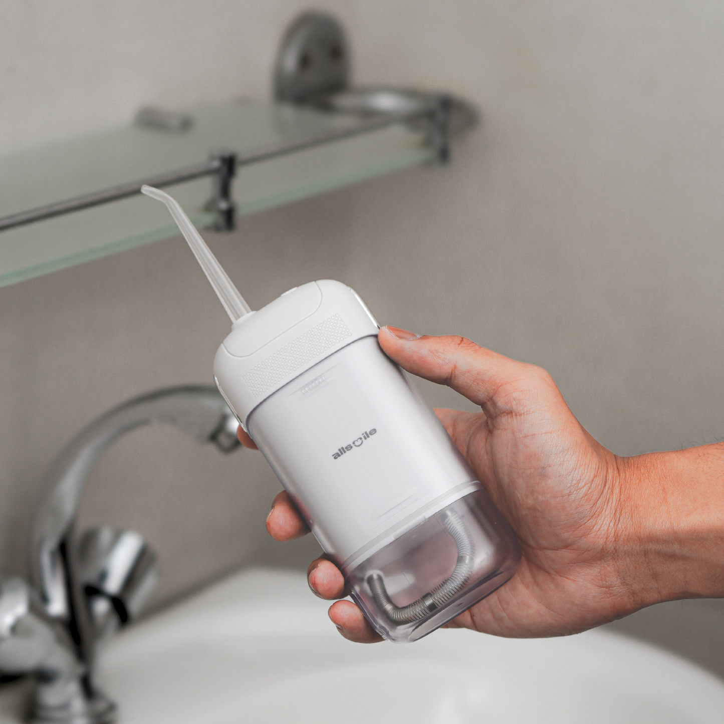 Allsmile portable oral irrigator being used in bathroom, perfect for home or travel dental care